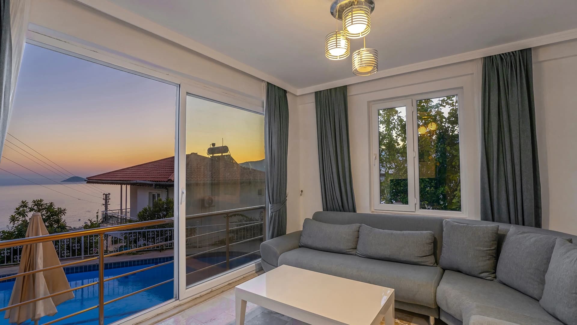 Modern living room with comfortable seating and expansive views through floor-to-ceiling windows.