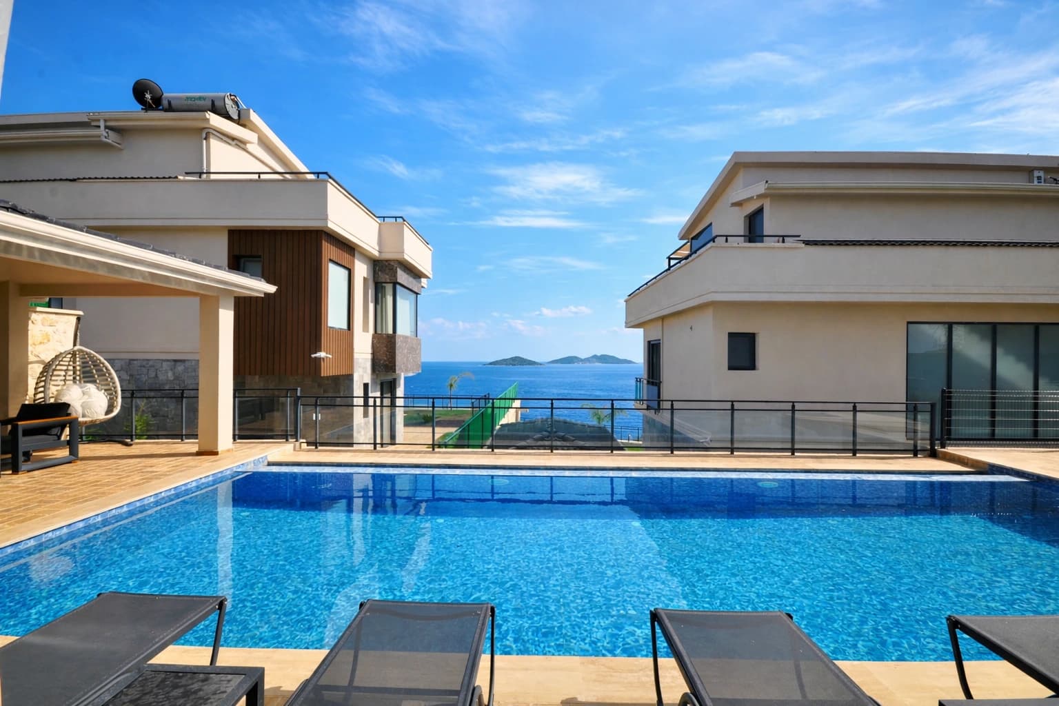 Stunning hillside pool terrace with panoramic sea and mountain views.