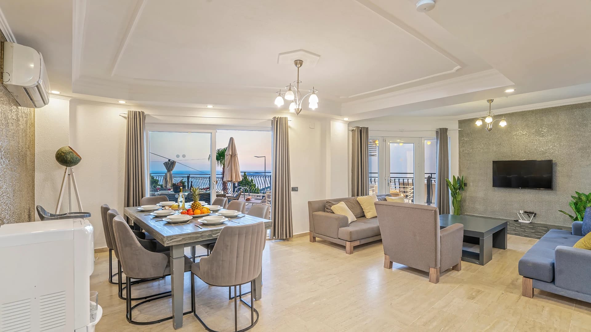 Spacious open-plan living and dining area with sea views and access to furnished balconies.