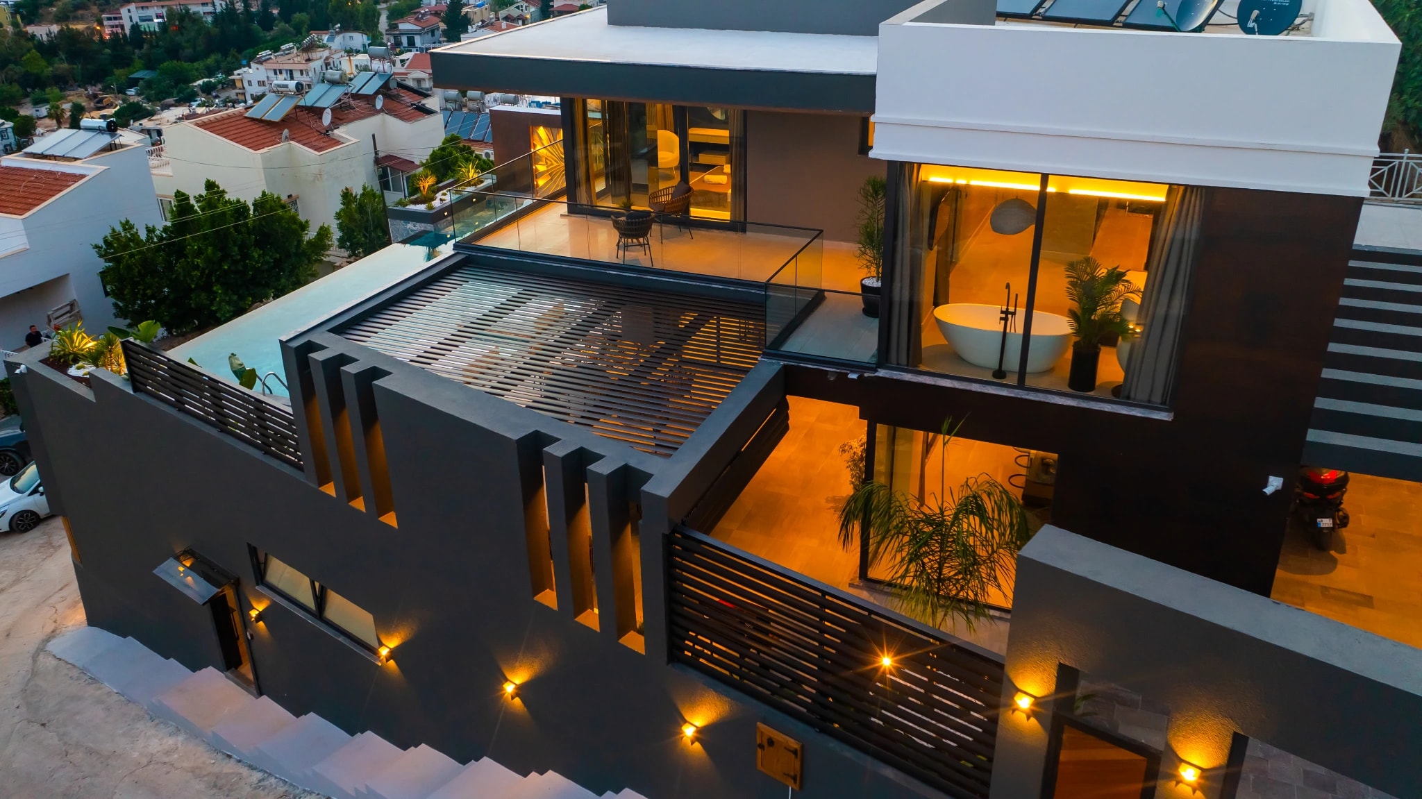 Modern villa facade with illuminated terrace and sleek architectural lines.
