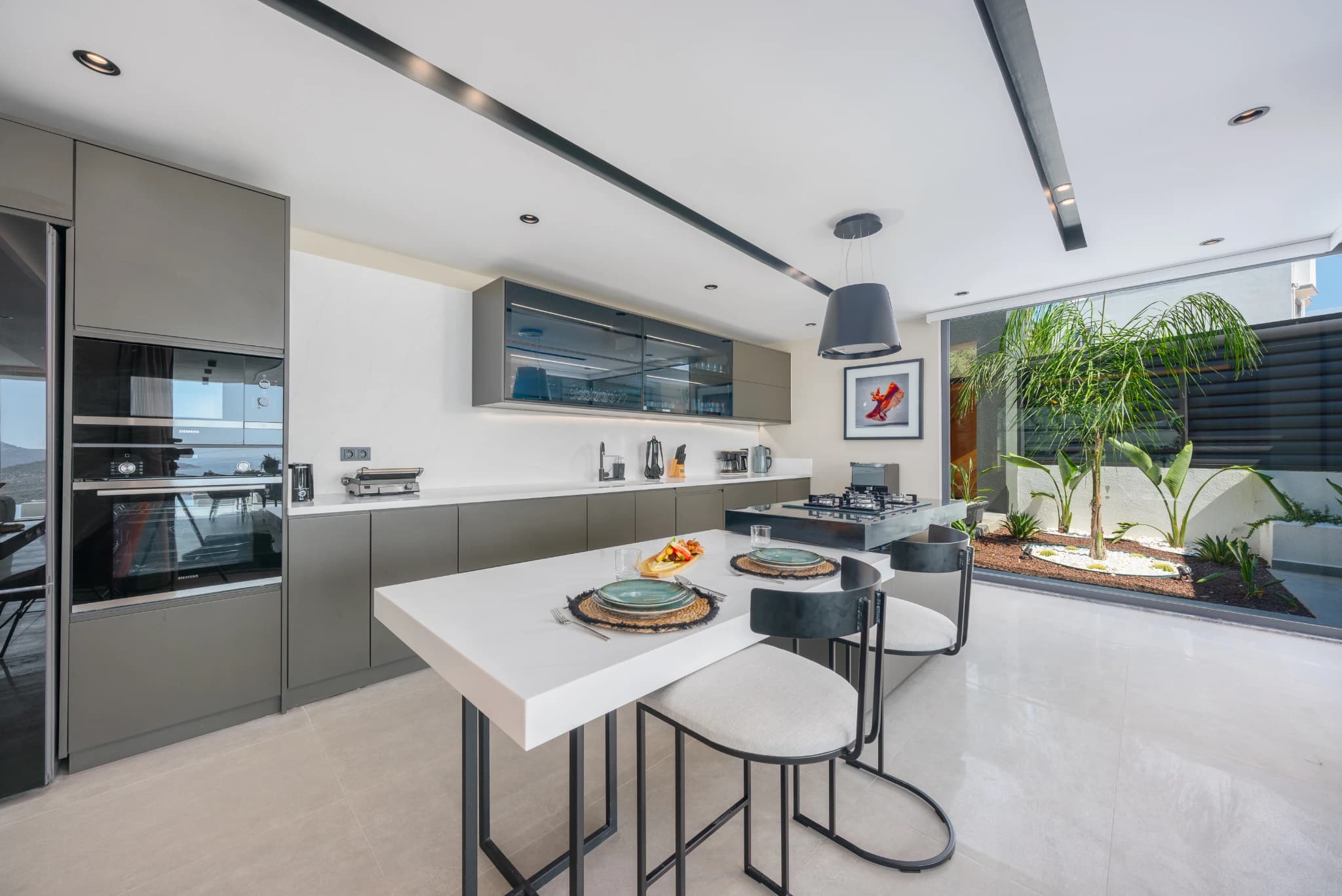 Contemporary kitchen with integrated appliances and garden access.