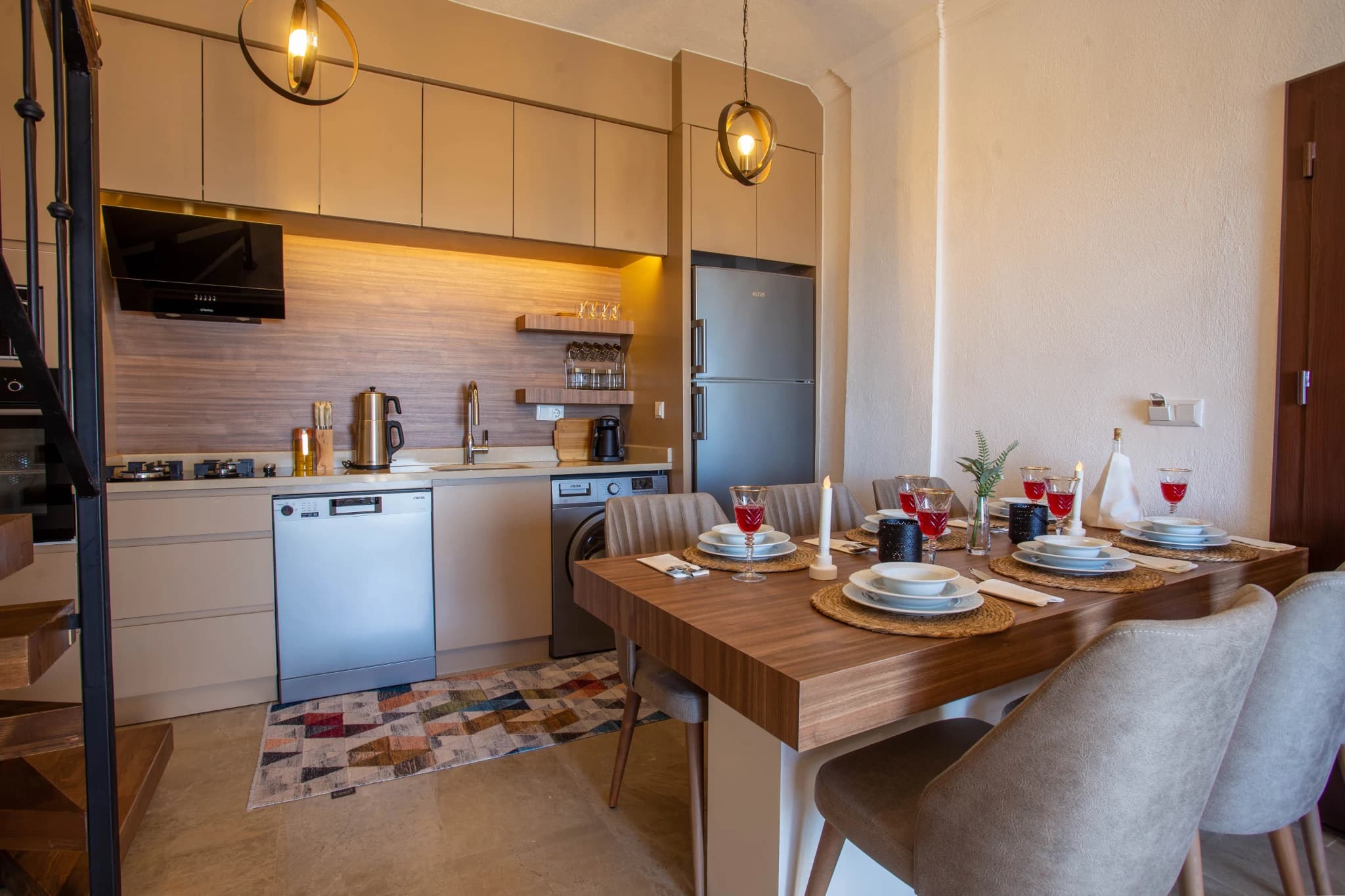Open-plan dining and kitchen area with wooden table set for dining.