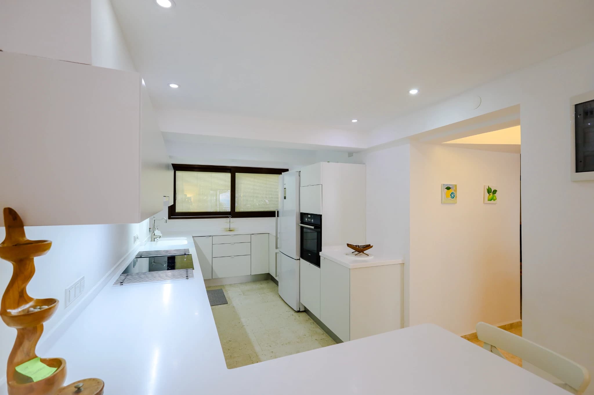 Bright kitchen with white cabinets and modern appliances.