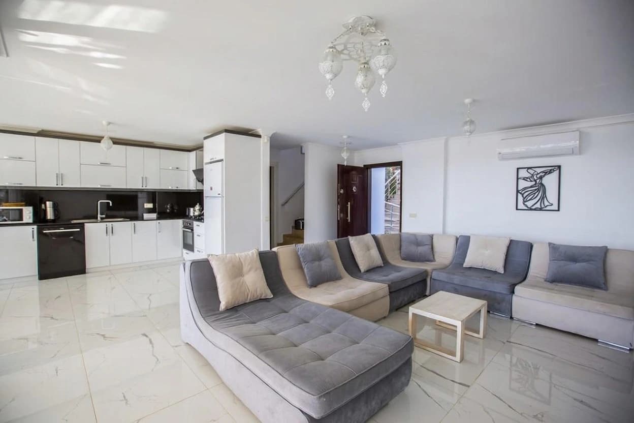 Bright open-plan living and kitchen space with contemporary furnishings.