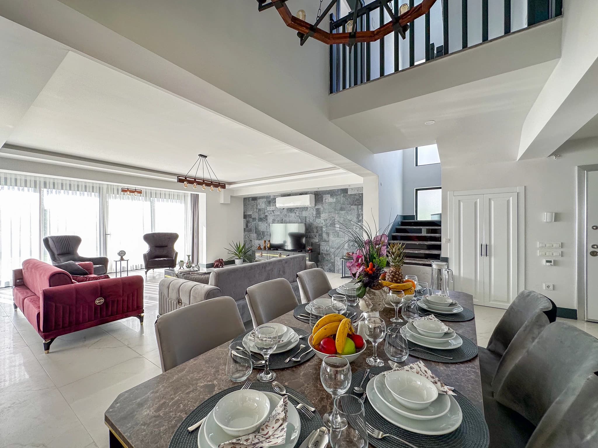 Spacious master bedroom with king bed, large wardrobe, and abundant natural light from floor-to-ceiling windows.