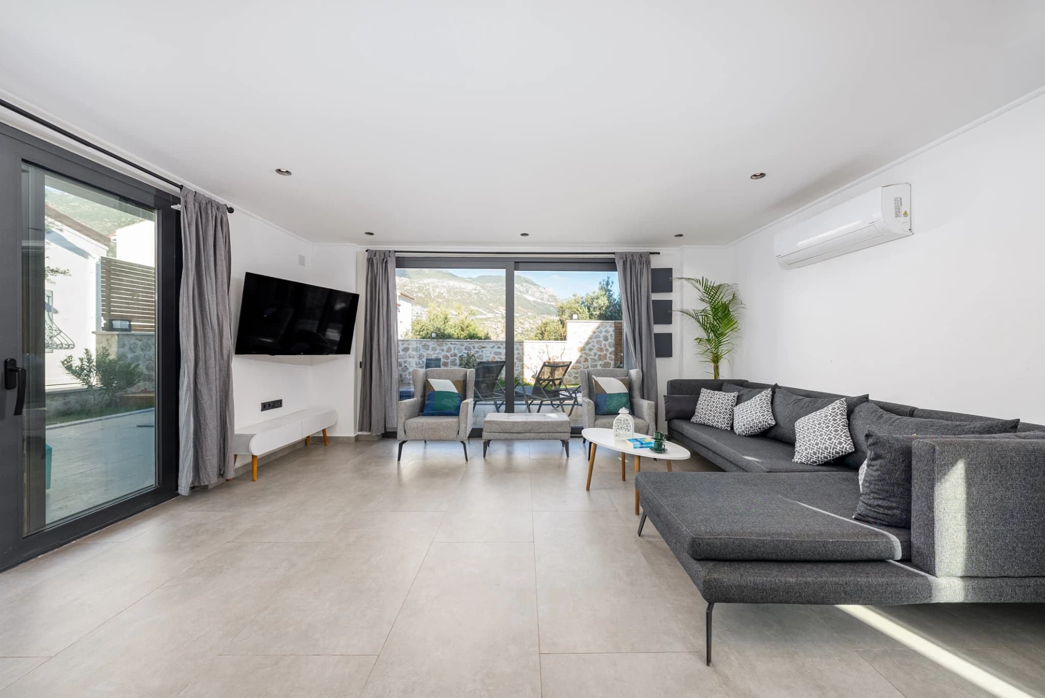 Bright living room with comfortable seating and balcony access.