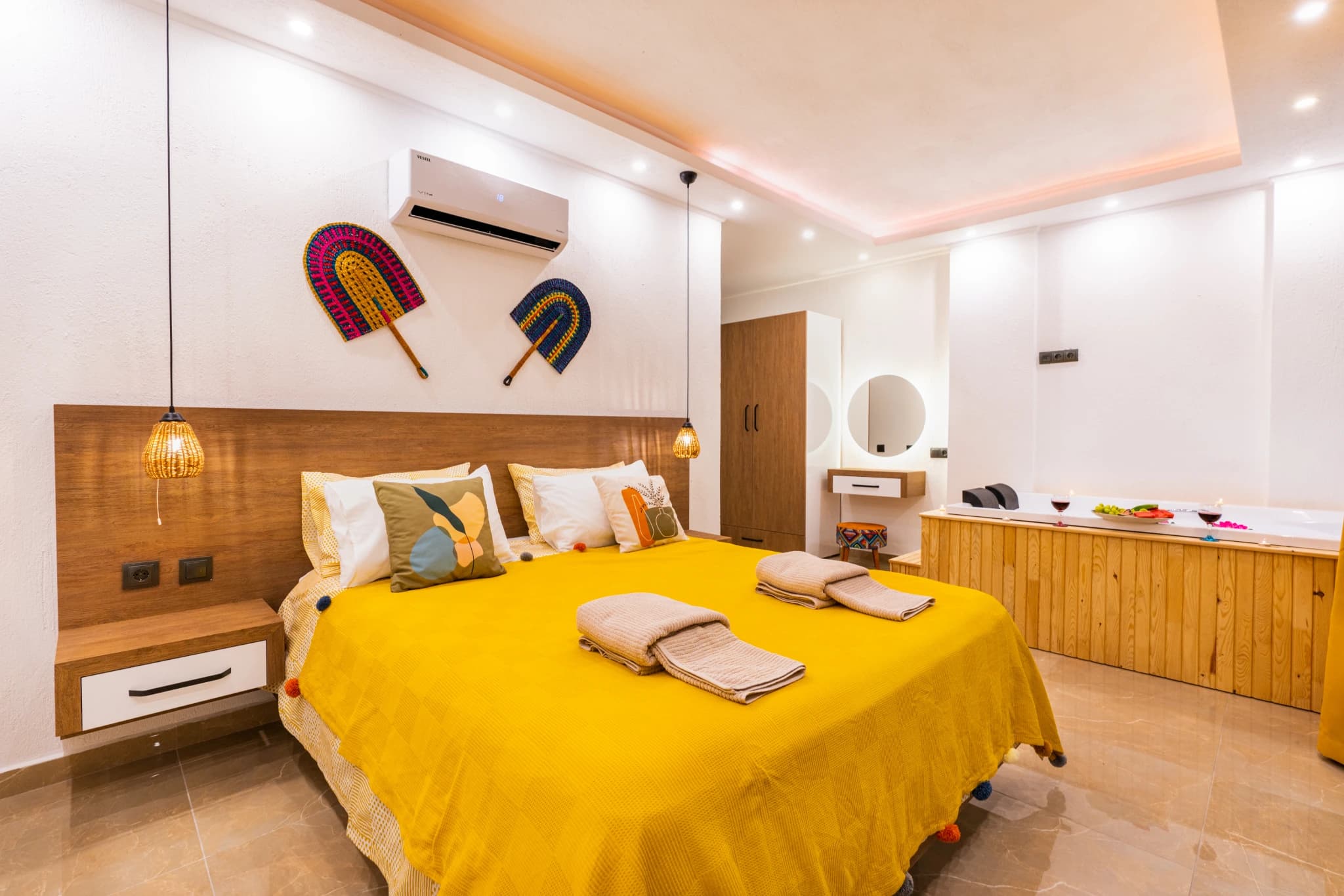 Bright bedroom with integrated vanity and comfortable seating area.