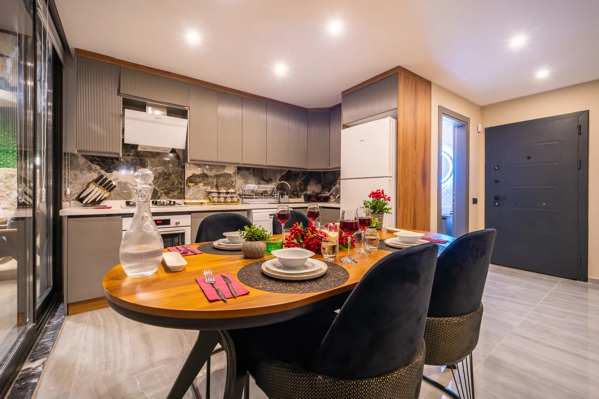 Elegant dining area with kitchen access and decorated table setting.