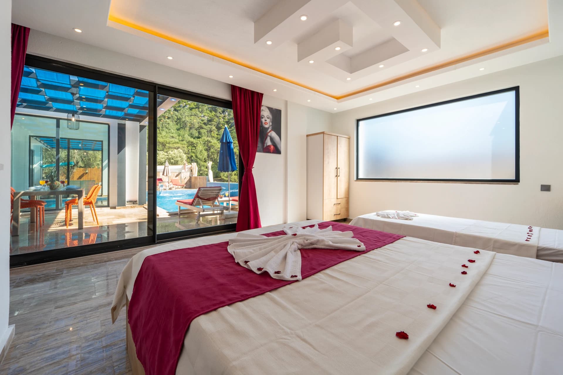 Luxurious bedroom with direct pool views and sliding glass door to terrace.
