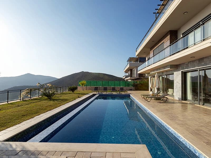 Stunning poolside terrace with private lap pool, sea and mountain views, and adjacent lounge areas.