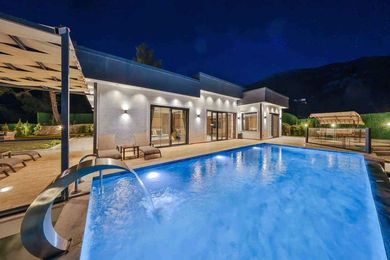 Luxurious illuminated pool with integrated spa features and contemporary architecture.