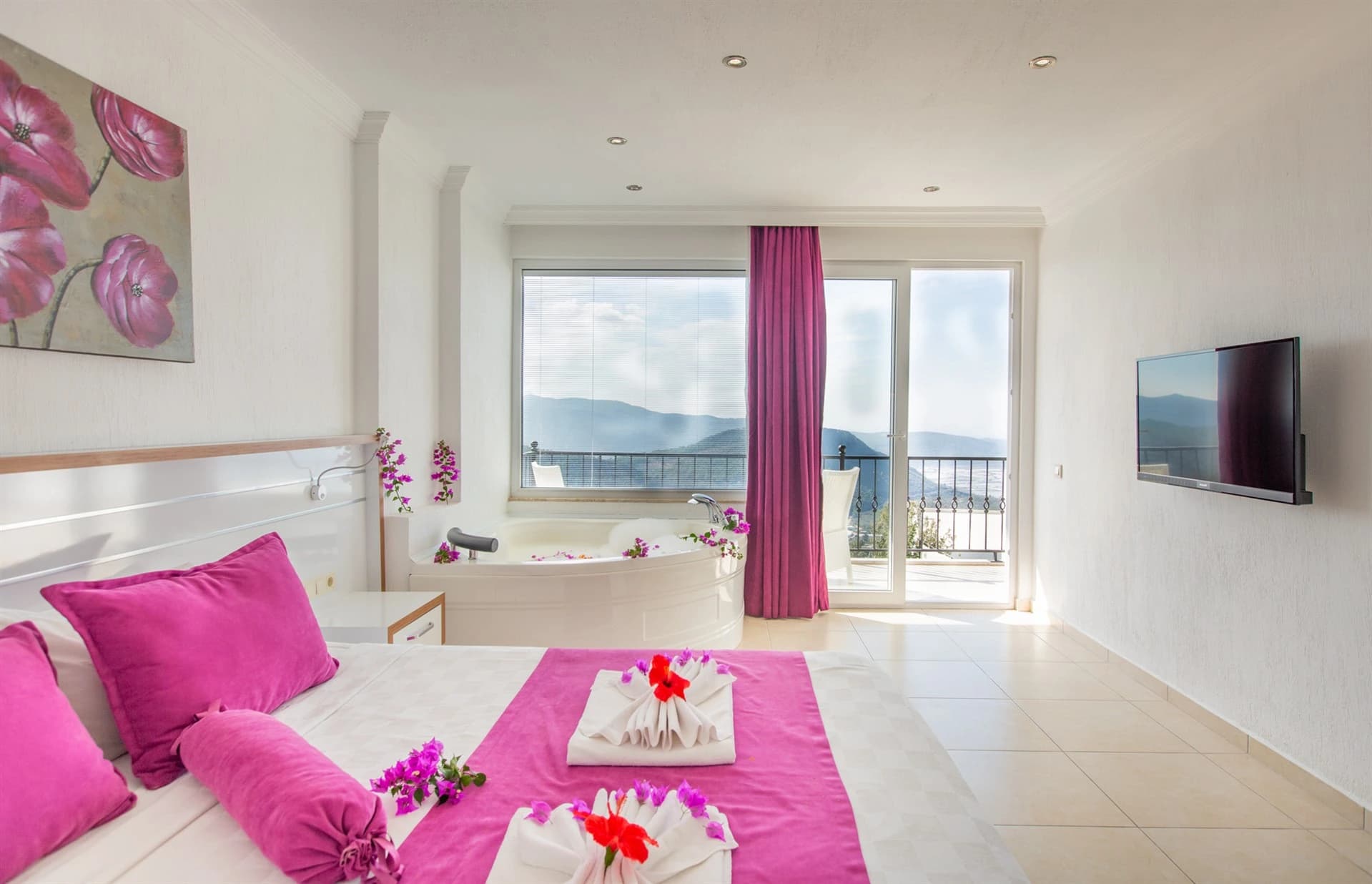 Luxury bedroom with king bed, mountain views, and private balcony access.
