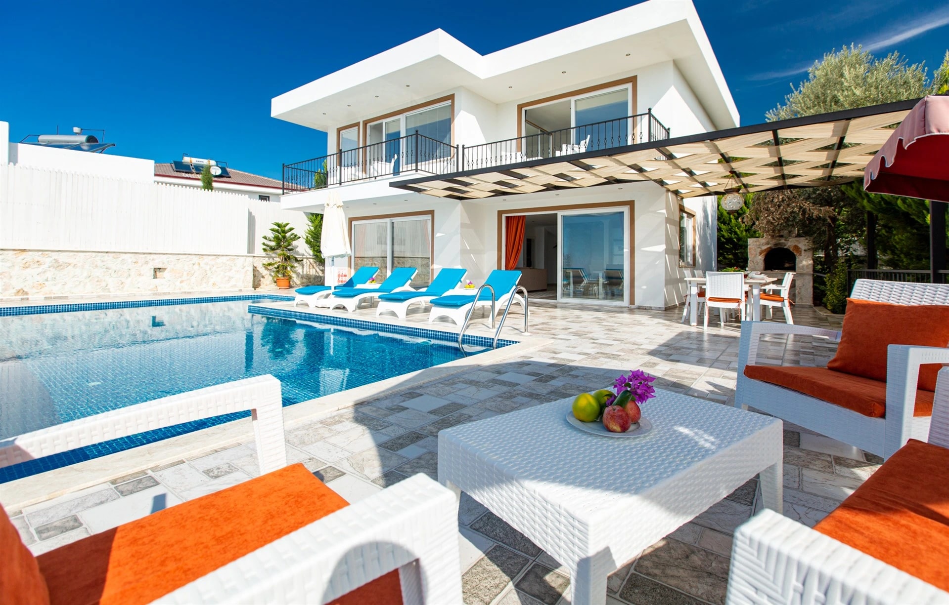Private pool with sun loungers and outdoor terrace surrounded by manicured gardens.