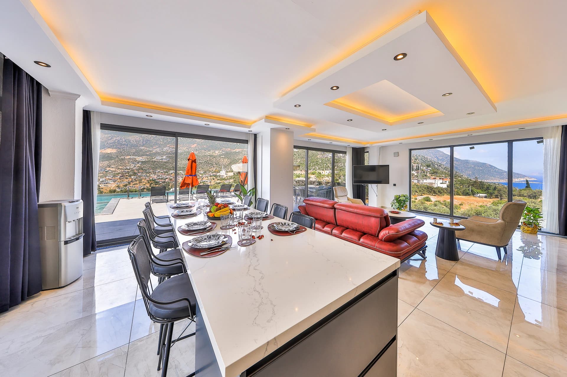 Contemporary dining area with expansive coastal and mountain vistas and integrated kitchen.
