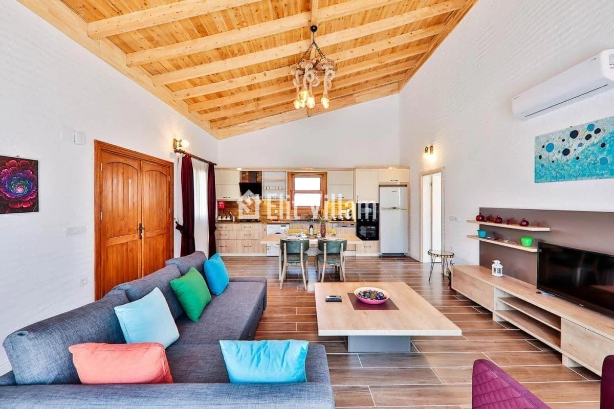 Main living space showcasing architectural details and integrated kitchen.