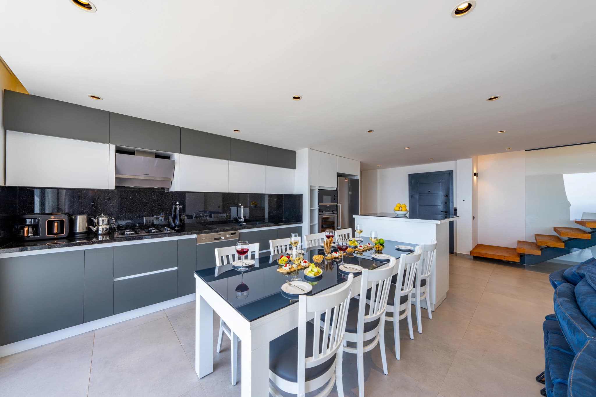 Open-plan kitchen-dining area with island seating and contemporary styling.