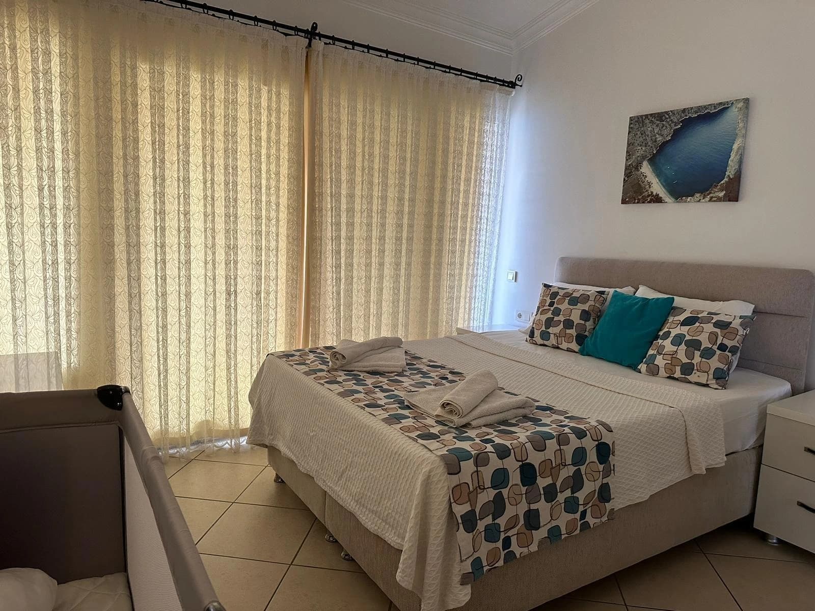 Spacious bedroom with comfortable double bed and soft natural lighting.
