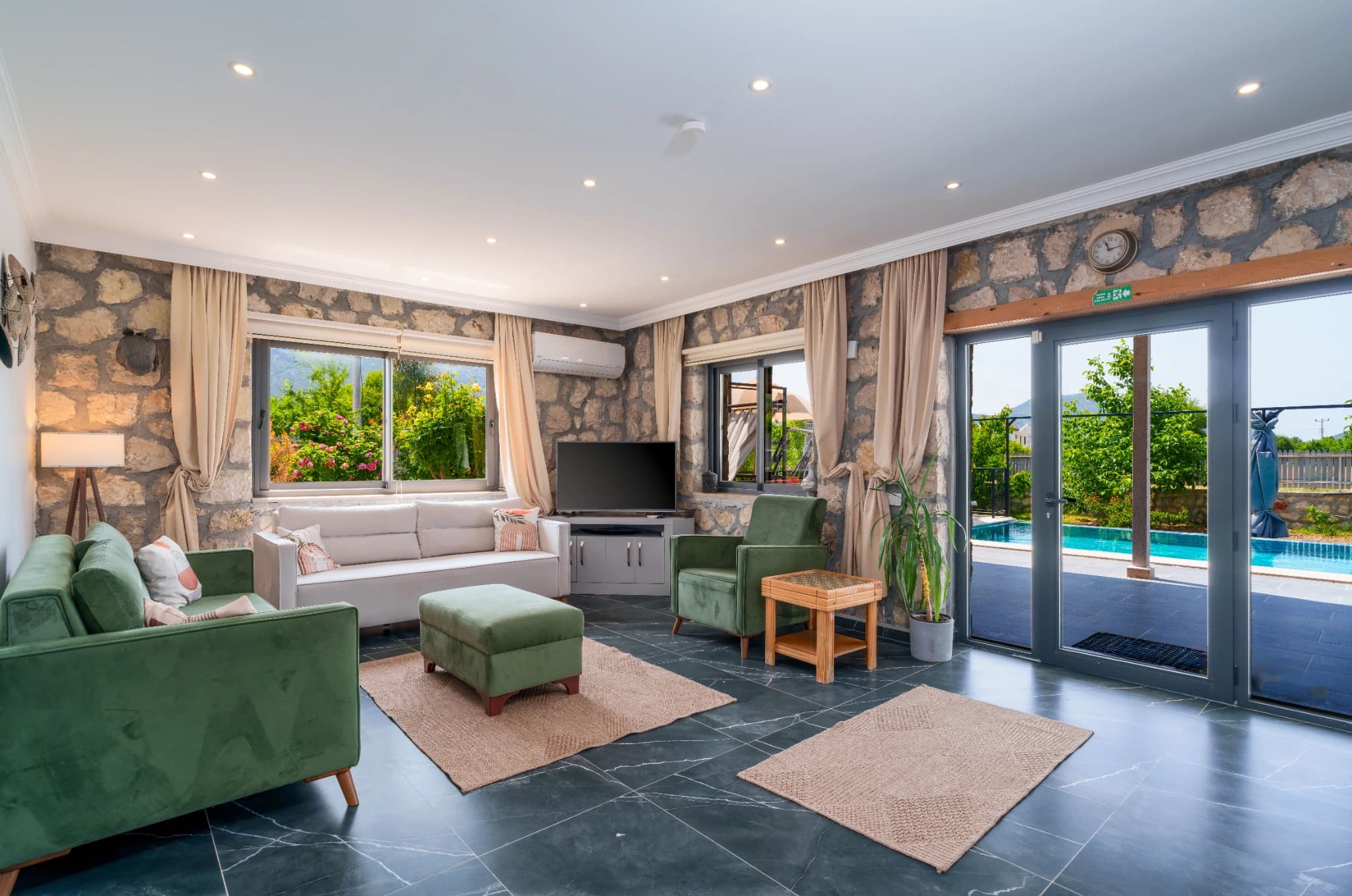 Living area with pool views and contemporary green furniture overlooking the terrace.