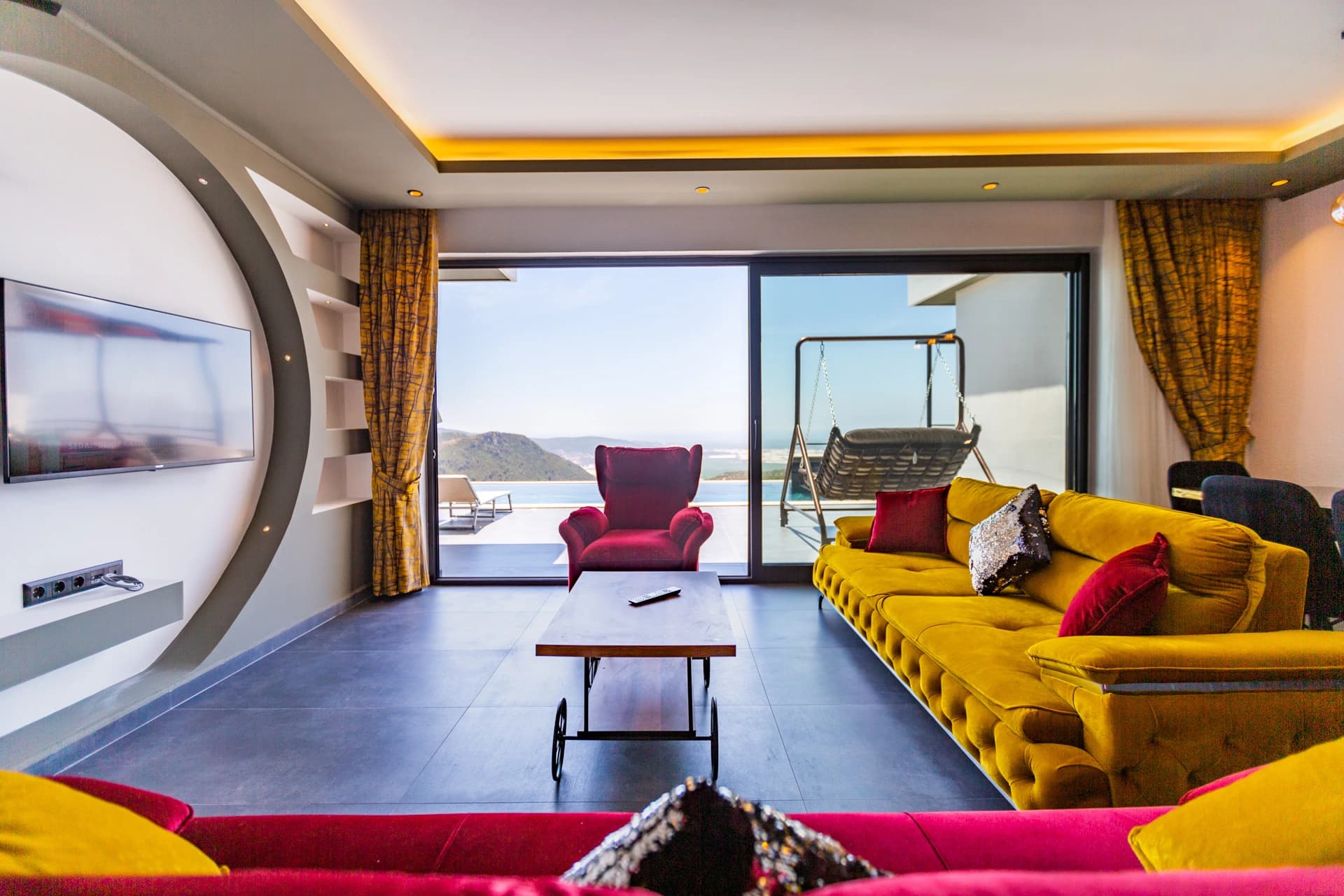 Contemporary living room with panoramic terrace views and minimalist furnishings.
