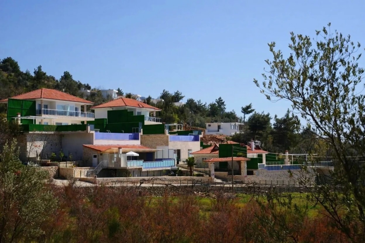 Hillside exterior view of the multi-level villa with Mediterranean architecture.