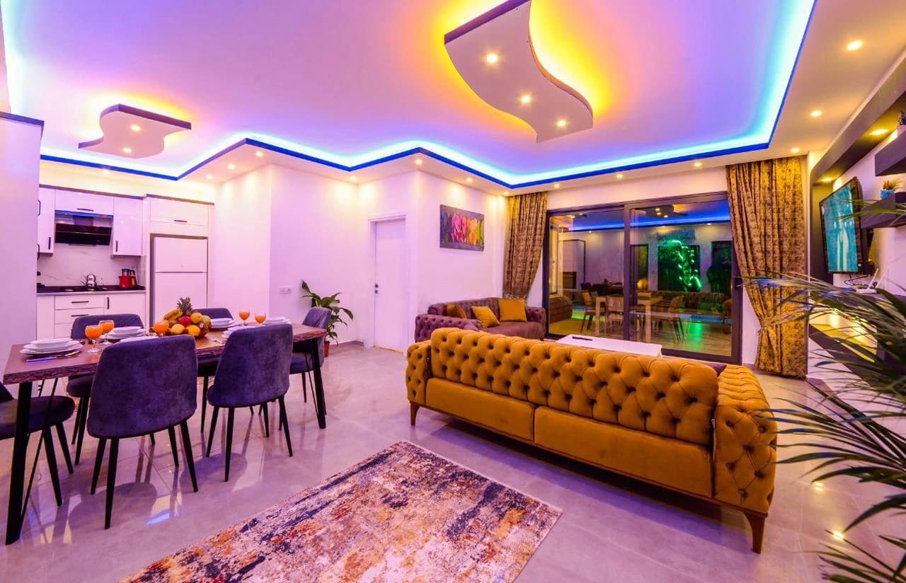 Luxurious open-concept living and dining space with contemporary furnishings and ambient lighting.