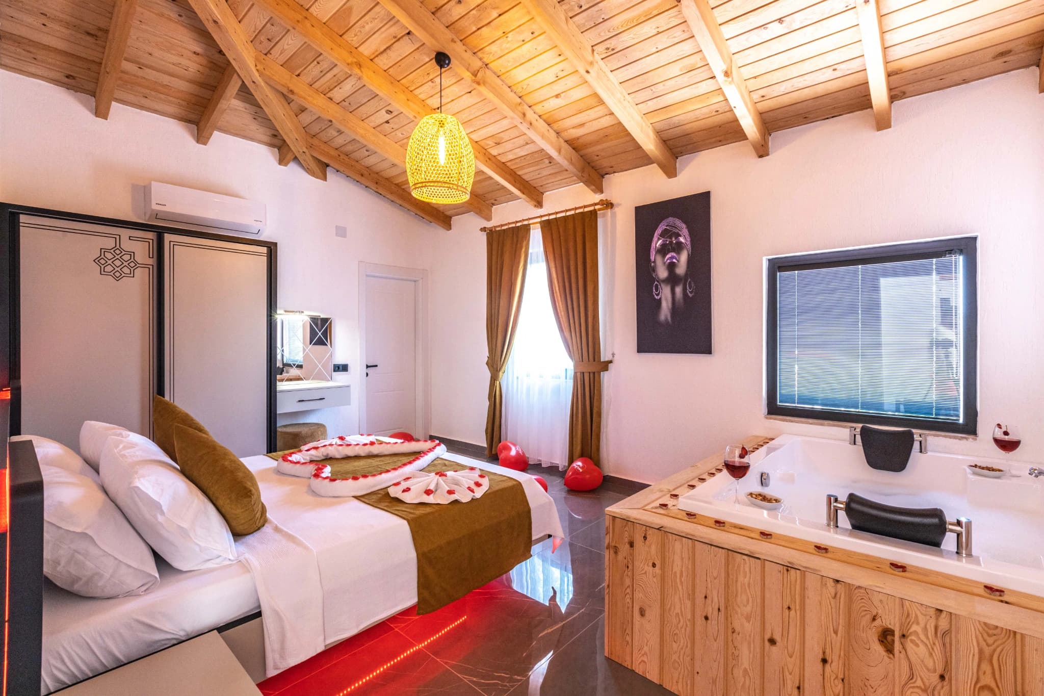 Master bedroom with king bed, ensuite bathroom access, and ambient lighting.