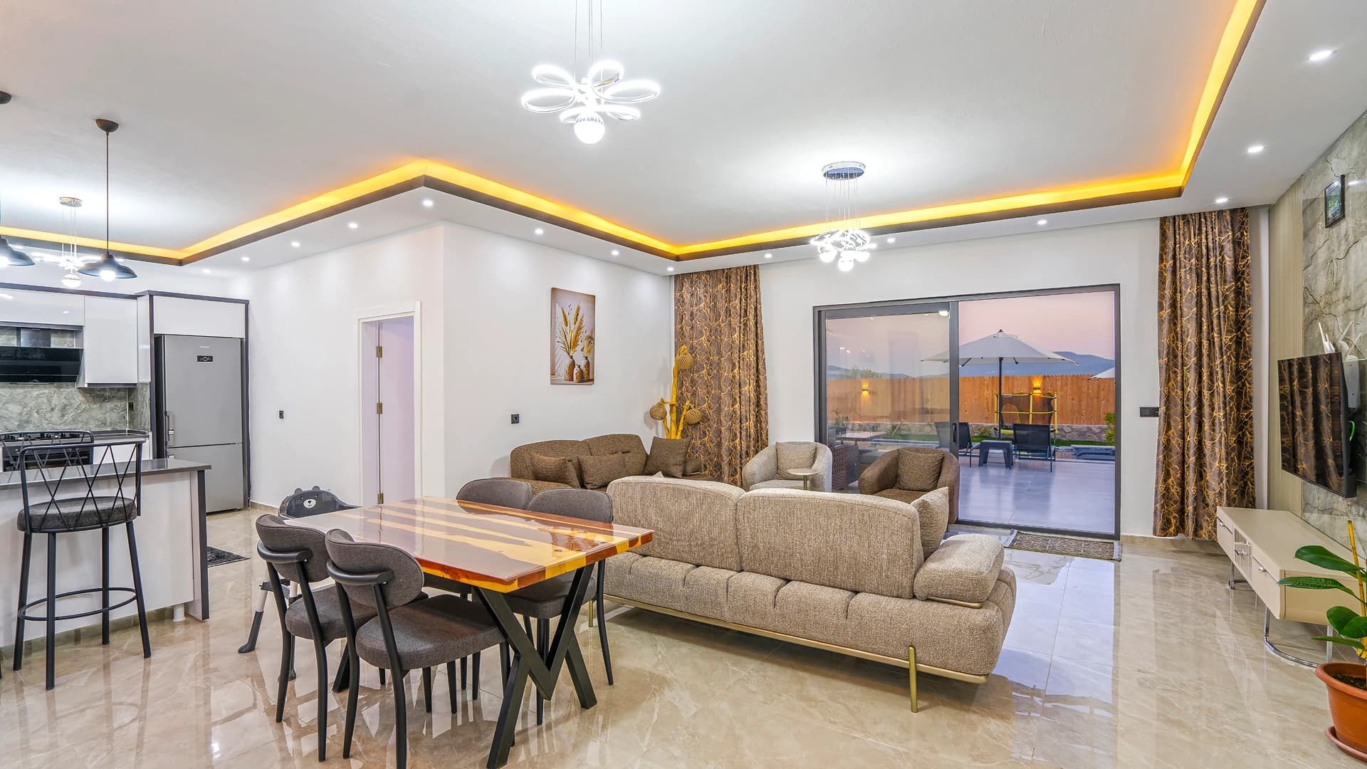 Elegant open-plan living space with panoramic mountain views and contemporary furnishings.
