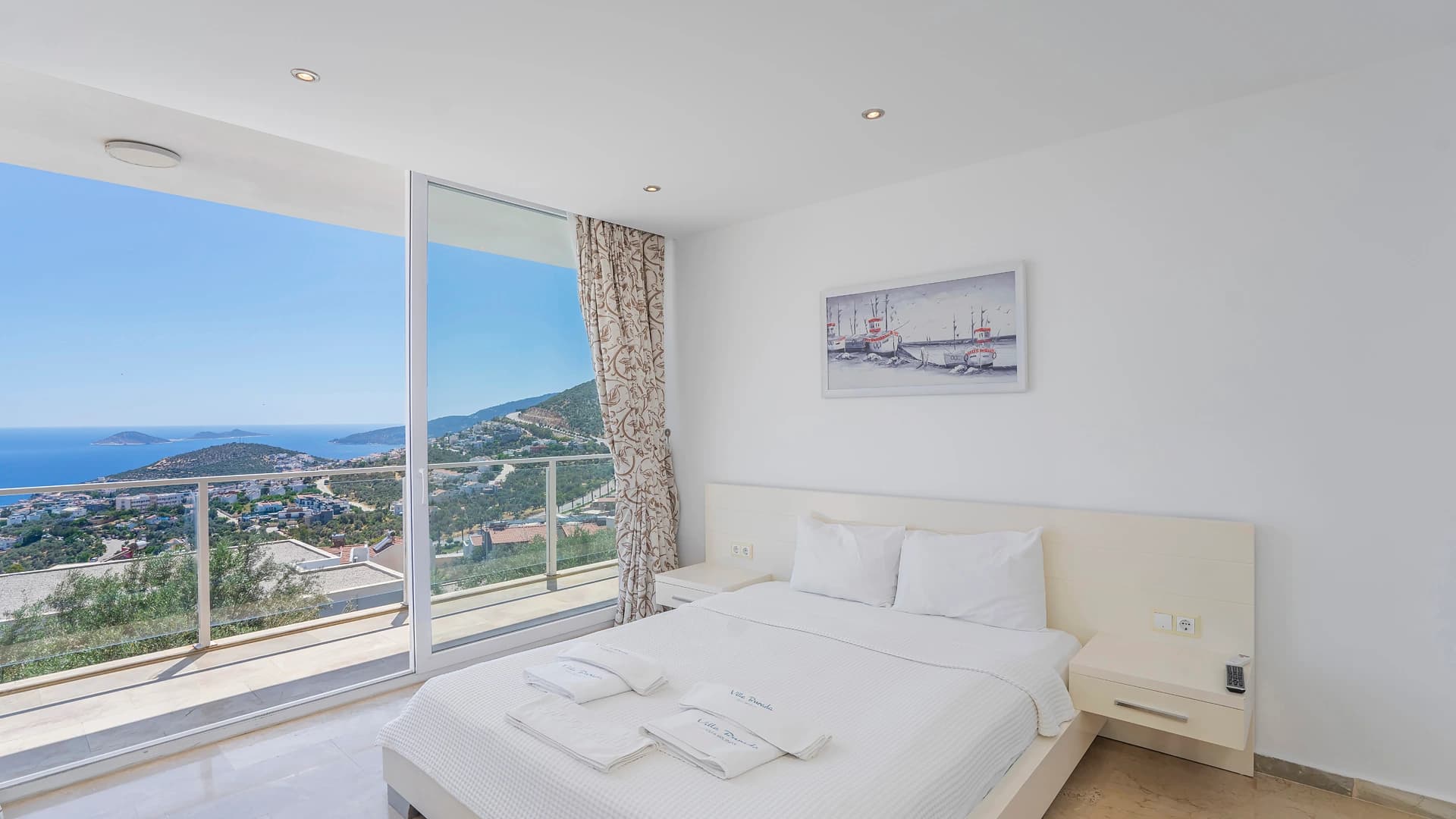 Bright bedroom with king bed and stunning sea view from private balcony.