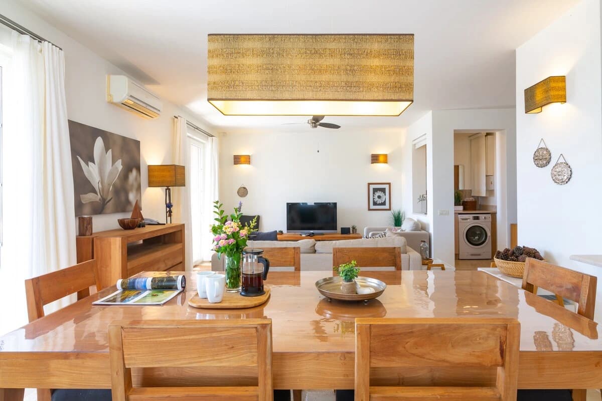 Open-plan living and dining room with modern furnishings and integrated utilities.