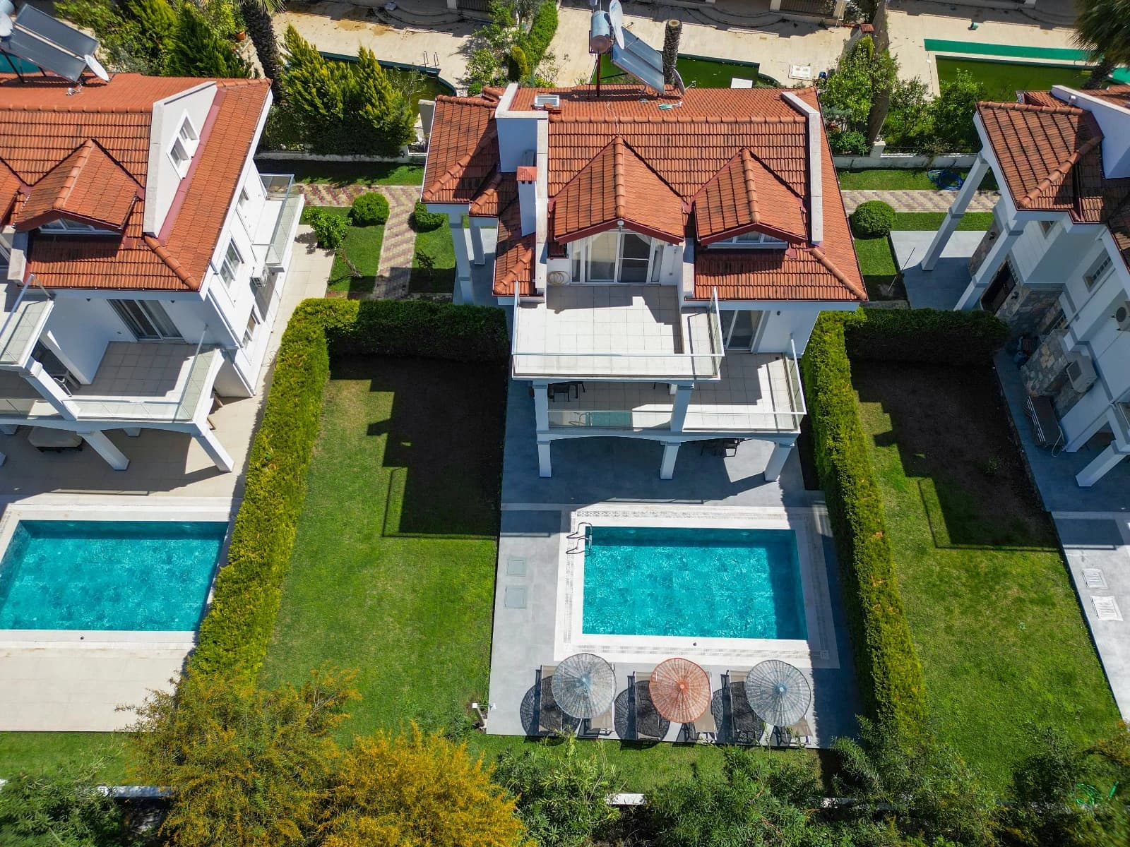 Aerial view of the villa with swimming pool and manicured grounds.