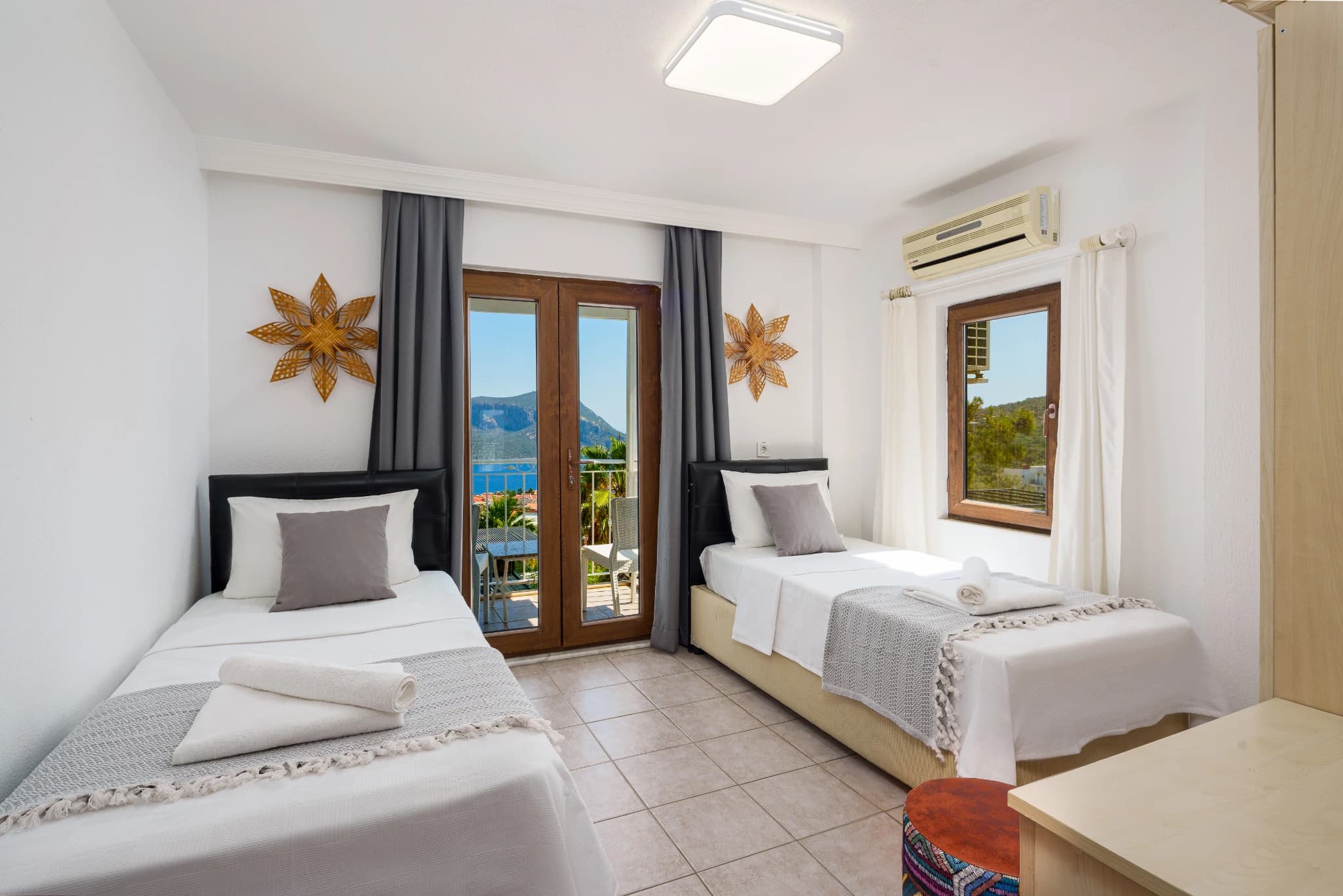 Twin bedroom with sea view balcony and air conditioning.