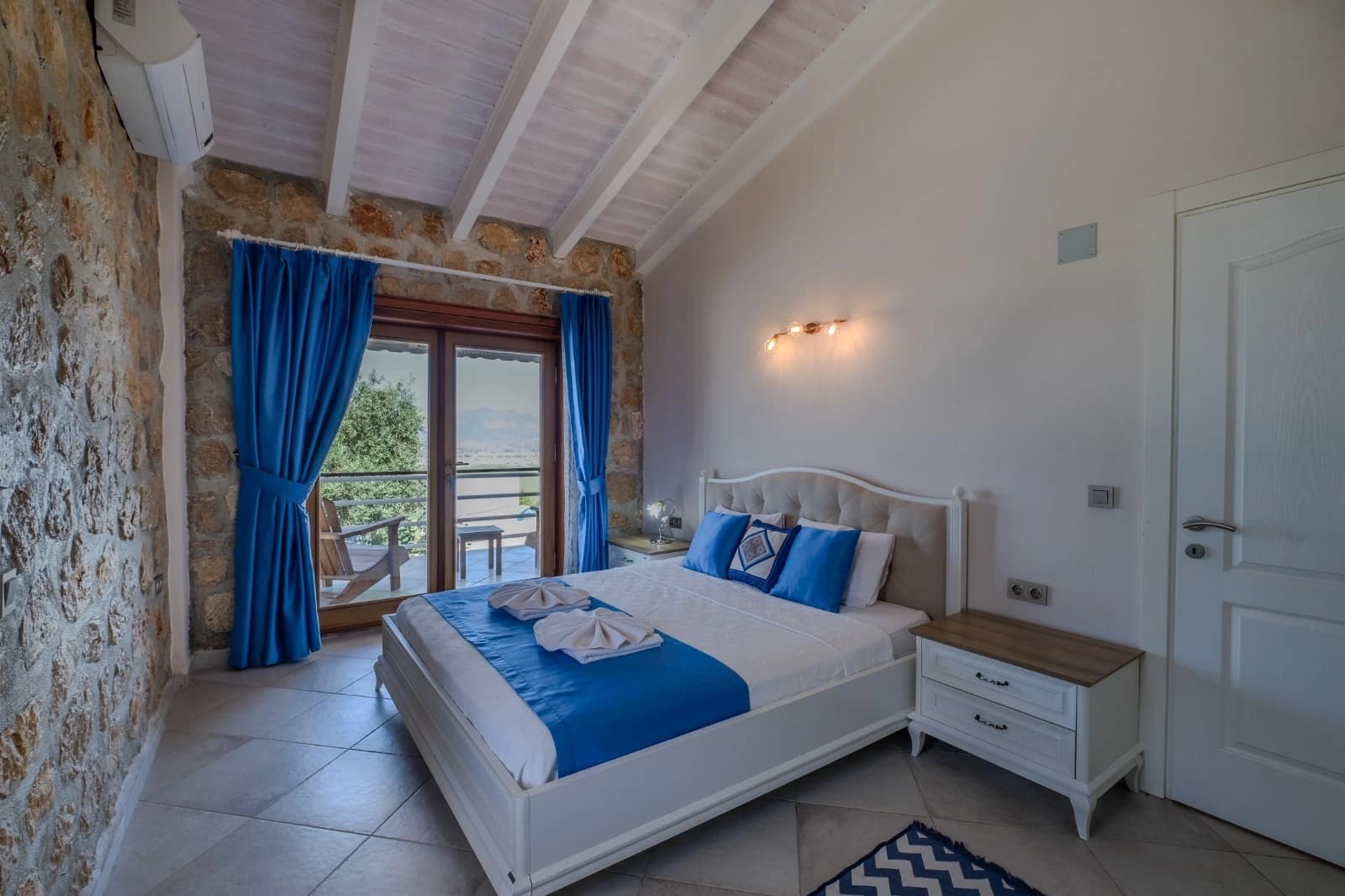 Master bedroom with king bed, balcony views, and ensuite bathroom.